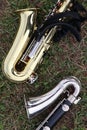Saxophone and bass clarinet on grass during marching band practice Royalty Free Stock Photo