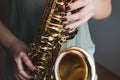 Saxophone girl player hands. Saxophonist playing jazz music. Alto sax musical instrument closeup. Painted nails Royalty Free Stock Photo