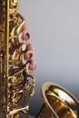 Saxophone girl player hands. Saxophonist playing jazz music. Alto sax musical instrument closeup. Painted nails