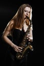 Saxophone player. Saxophonist woman playing sax Royalty Free Stock Photo