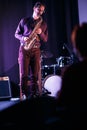 Saxophone player on stage. Silhouette of listener on a foreground Royalty Free Stock Photo