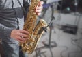 Saxophone playing. Hands of a man playing the saxophone. Dark background. Copy space