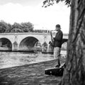 Saxophonist in border Seine river in Paris Royalty Free Stock Photo