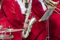 Saxophonist in a red suit close-up. Concept: playing the saxophone, music. Saxophone jazz music instrument Alto sax saxophonist Royalty Free Stock Photo