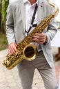 Saxophonist with saxophone prepares to perform at the holiday Royalty Free Stock Photo