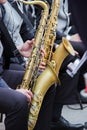 Saxophonists playing in a jazz band, dressed in men`s classic vest and trousers.