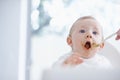 Say aaaah....Cropped image of a baby boy opening his mouth for his mother to feed him. Royalty Free Stock Photo