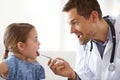 Say aaah. an adorable young girl with her pediatrician.