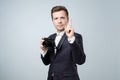 Say cheese concept. Handsome young man in suit holding in arms small camera ready to make a shoot. Royalty Free Stock Photo