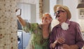 Say cheese. a happy senior couple standing together in costume and using a cellphone to take selfies. Royalty Free Stock Photo