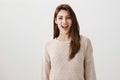 Say cheese and smile widely to camera. Portrait of pretty brunette european female in casual sweater, smiling broadly Royalty Free Stock Photo