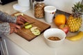 Say good morning to your body. an unidentifiable young woman preparing a healthy breakfast in her kitchen at home. Royalty Free Stock Photo