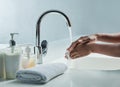 Say goodby to bacteria. a man washing his hands in a bathroom sink. Royalty Free Stock Photo