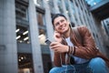 Say hello. Happy man meeting someone. Happy man listening to music with headphones from a smartphone on the street. Royalty Free Stock Photo