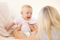 Say hello to mommy. A baby girl playing with her mother and laughing. Royalty Free Stock Photo