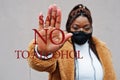 Say no to alcohol. African american woman, wear black face mask show stop hand sign