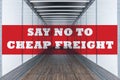 Say no to cheap freight written on empty commercial semi trailer interior. Concept of american truckers protest due to load rates