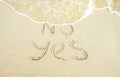 Say yes to life. No and Yes words written on the sand where No is getting washed away by the wave Royalty Free Stock Photo