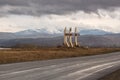 Sayanogorsk, Khakassia, Russia - a road sign-monument stella at the entrance to the city. Soviet vintage road decoration. Royalty Free Stock Photo