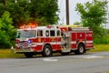 Sayreville NJ USA - Jujy 02, 2018: Firetruck driving on a road flashing blue lights a accident damaged car Royalty Free Stock Photo