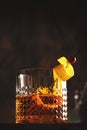 Sazerac, classic alcoholic cocktail with cognac, bourbon, absinthe, bitters, sugar and lemon zest. Old wooden background with copy