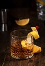 Sazerac cocktail with cognac, bourbon, absinthe, bitters, sugar and lemon zest. Old wooden bar counter background with copy space Royalty Free Stock Photo