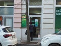 Sberbank. A depositor or client stands in front of the entrance to the branch of a subsidiary of Sberbank of Russia