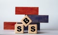 SBS - acronym on wooden cubes on a background of colored block on a light background