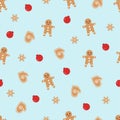 Blue seamless Christmas background with gingerbread men and red fruits, brown mittens and snowflakes Royalty Free Stock Photo