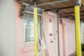 Scaffold outside the window and door of a pink British house Royalty Free Stock Photo