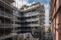 scaffold with view of construction site, with builders working on the ground floor Royalty Free Stock Photo