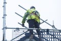 Scaffold worker dismantling access structure on construction building site Royalty Free Stock Photo