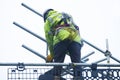 Scaffold worker dismantling access structure on construction building site Royalty Free Stock Photo