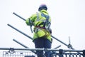 Scaffold worker dismantling access structure on construction building site Royalty Free Stock Photo