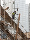 A scaffolder working on top of a scaffold construction. Royalty Free Stock Photo