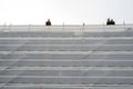 Scaffolding covered with white safety net in a city. House reconstruction work on progress. Construction industry Royalty Free Stock Photo