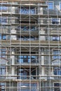 Scaffolding at the facade of a building under construction, multi-storey building, without people Royalty Free Stock Photo