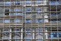 Scaffolding at the facade of a building under construction, multi-storey building, without people Royalty Free Stock Photo