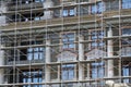 Scaffolding at the facade of a building under construction, multi-storey building, without people Royalty Free Stock Photo