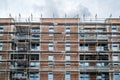 Scaffolding on house facade, apartment buildingwith scaffold