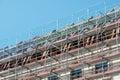 Scaffolding on house facade, building under construction Royalty Free Stock Photo