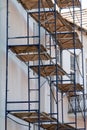 scaffolding made of metal profile and wooden decking along the building during the renovation. Restoration of an old building in Royalty Free Stock Photo