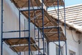 scaffolding made of metal profile and wooden decking along the building during the renovation. Restoration of an old building in Royalty Free Stock Photo