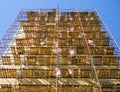 Scaffolding mounted at the end wall of the building for its insulation