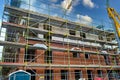 Scaffolding near a high-rise brick house under construction in Germany