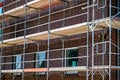 Scaffolding near a high-rise brick house under construction in Germany.