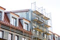 Scaffolding near house under construction. facade renovation.