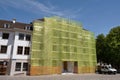 Scaffolding with protective yellow green net of a building in Basel, Switzerland Royalty Free Stock Photo