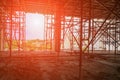 Scaffolding steel group silhouette in work construction site building with sunset light Royalty Free Stock Photo
