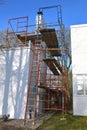 Scaffolding surround a chimney under repair Royalty Free Stock Photo